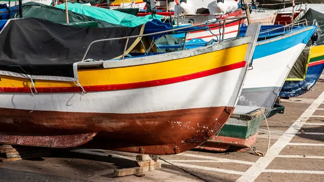 The harbour of Câmara de Lobos with brightly painted fishing boats, Madeira