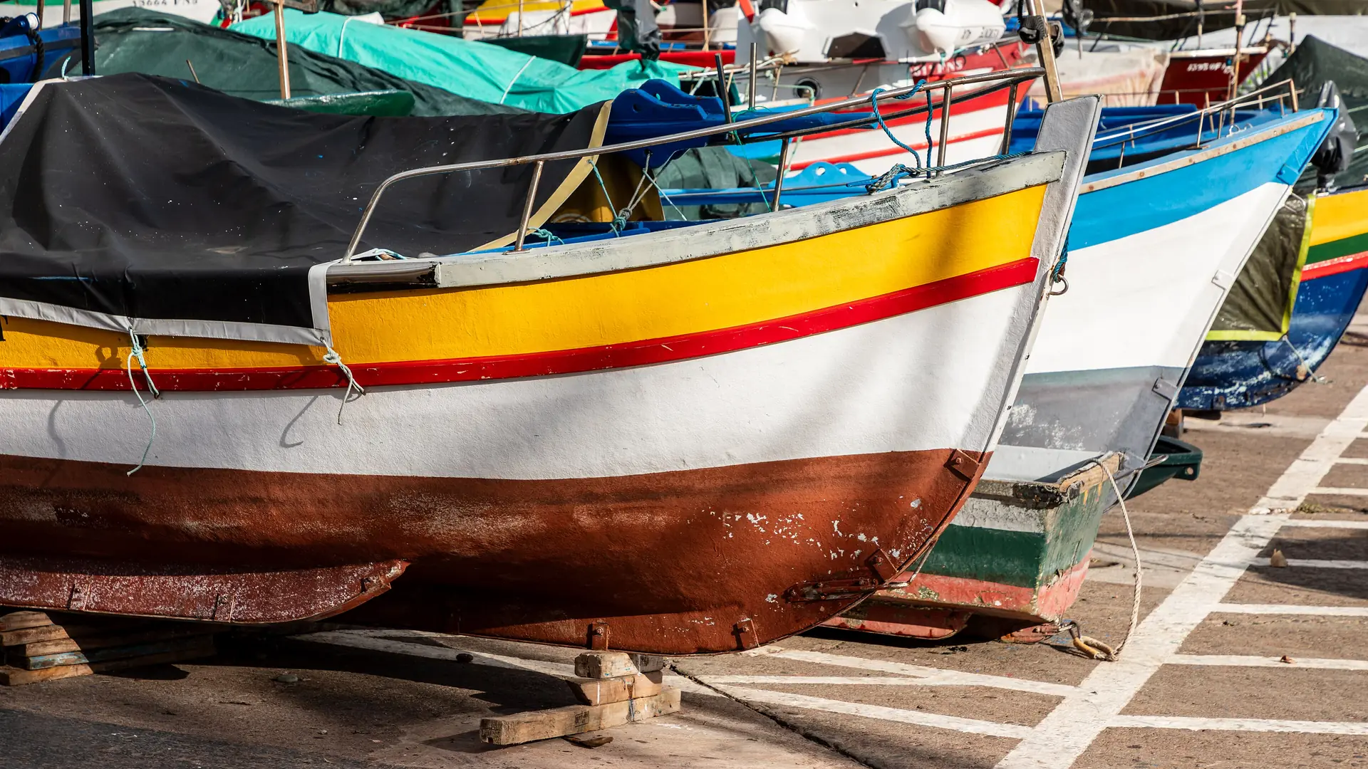 The harbour of Câmara de Lobos with brightly painted fishing boats, Madeira