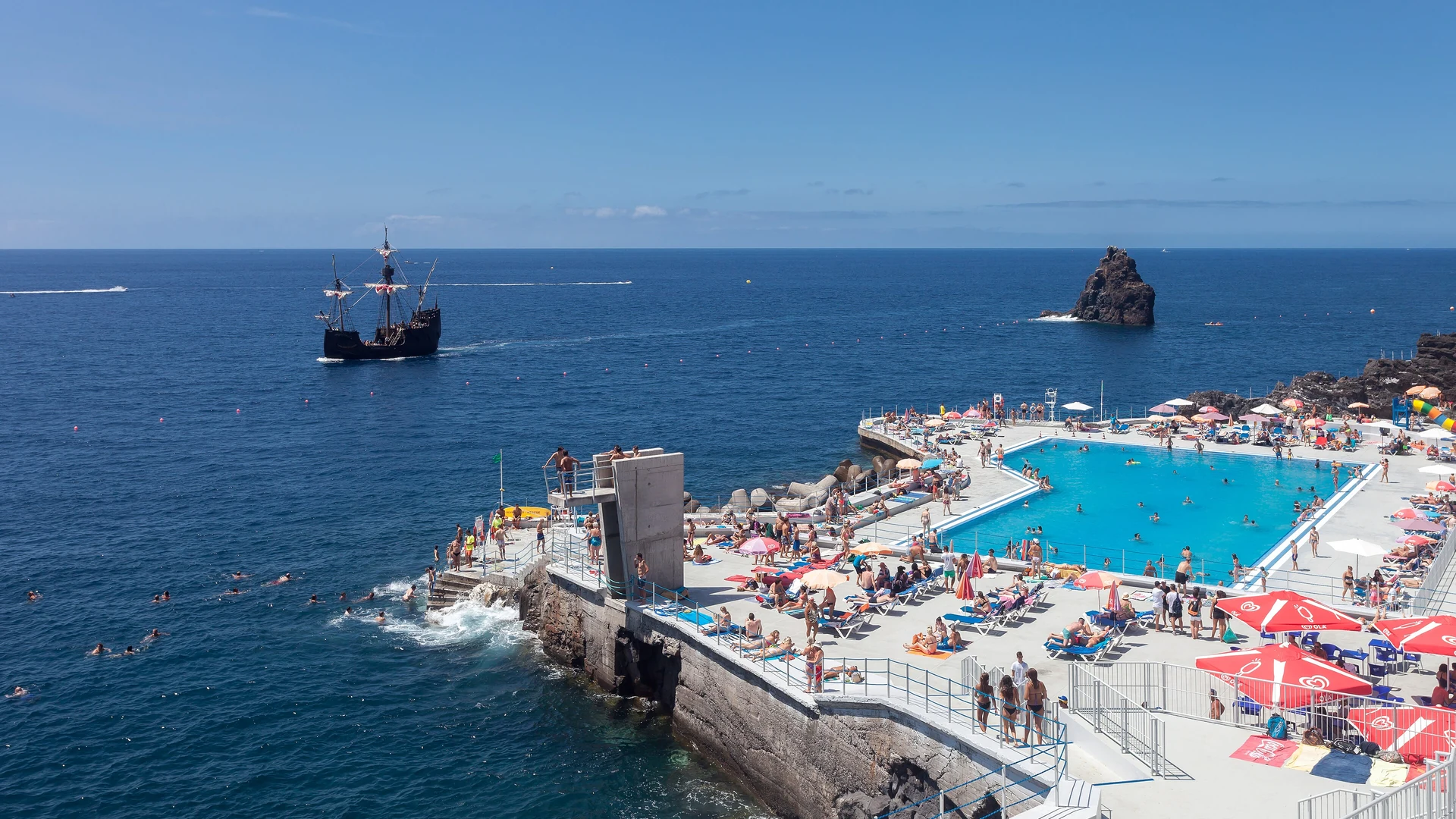 The blue seafront swimming pools of the Lido complex above the Atlantic in Funchal, Madeira