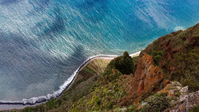 The turquoise sea and terraced fields far below the Cabo Girão clifftop, Madeira