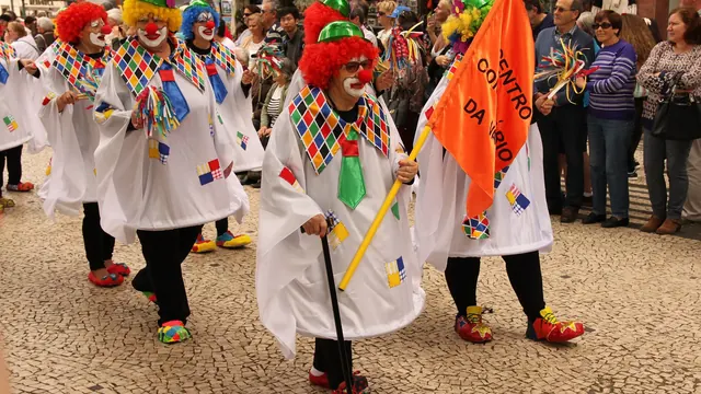 Costumed performers in colourful harlequin outfits at the Carnival parade in Funchal, Madeira