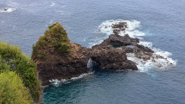 Wild Atlantic waves breaking around volcanic sea stacks at Seixal on Madeira's north coast
